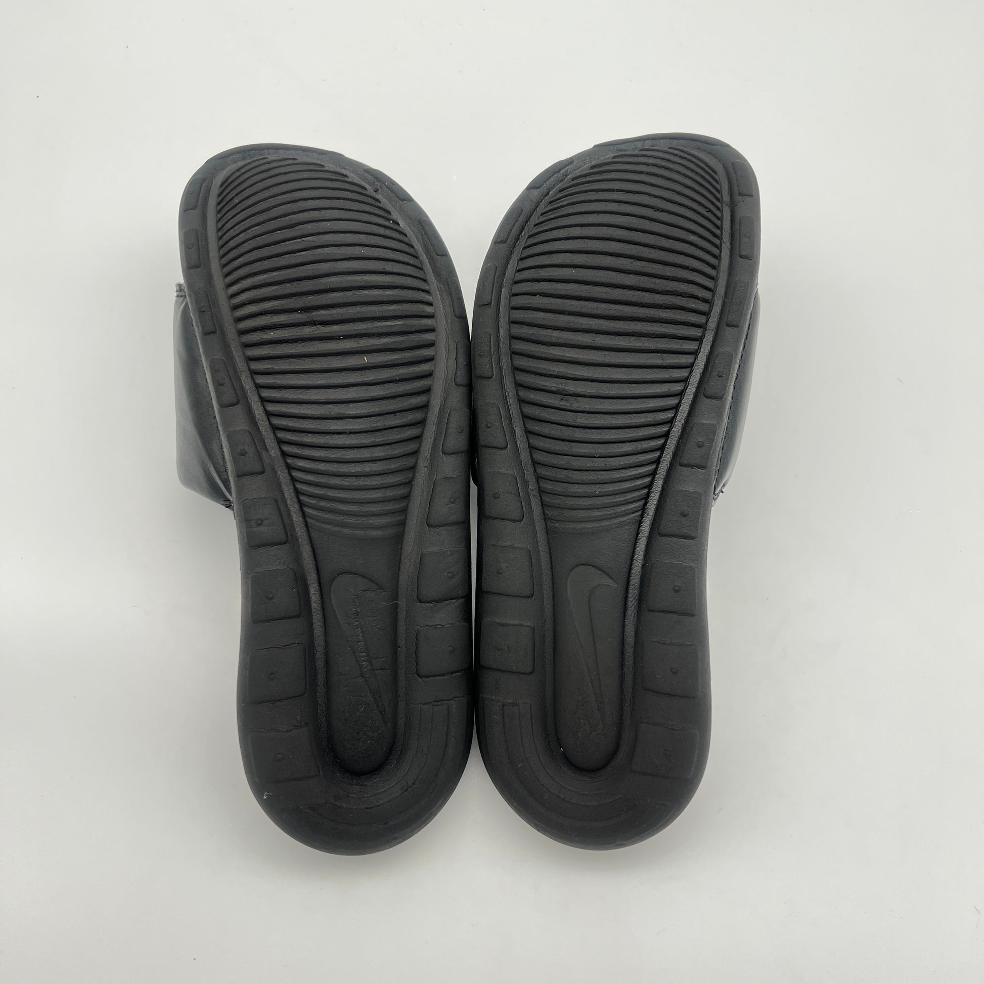 Black rubber sandals on a white background