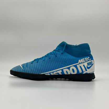 Blue Nike soccer shoe on a gray background