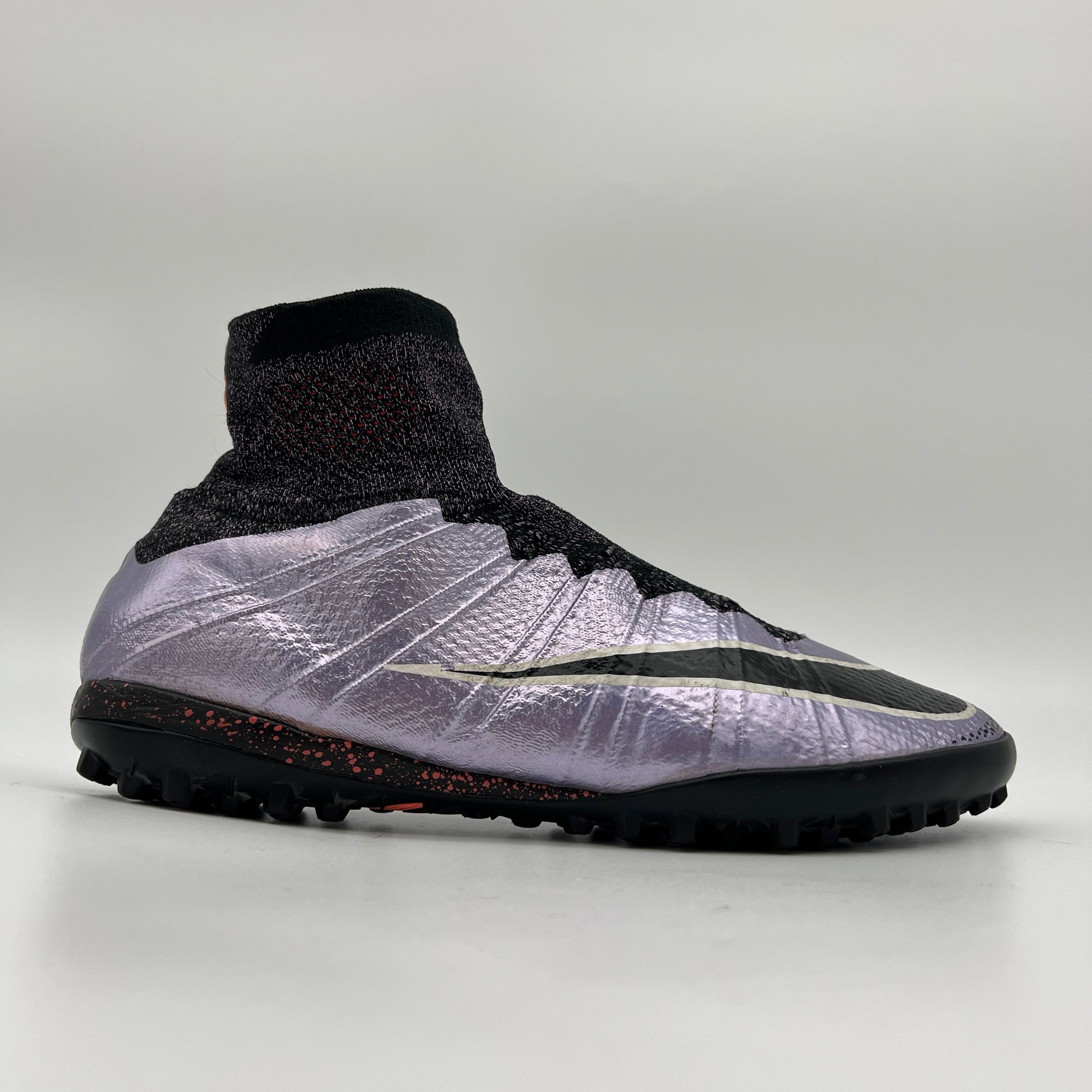 Profile view of a Nike MercurialX Proximo TF turf football boot in metallic Urban Lilac with a black Flyknit Dynamic Fit collar and a speckled outsole