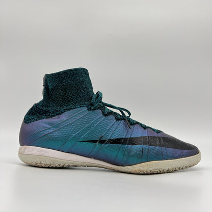 Side profile of an iridescent Squadron Blue Nike MercurialX Proximo IC indoor soccer shoe with a black Nike swoosh and a high-top Flyknit sock collar.
