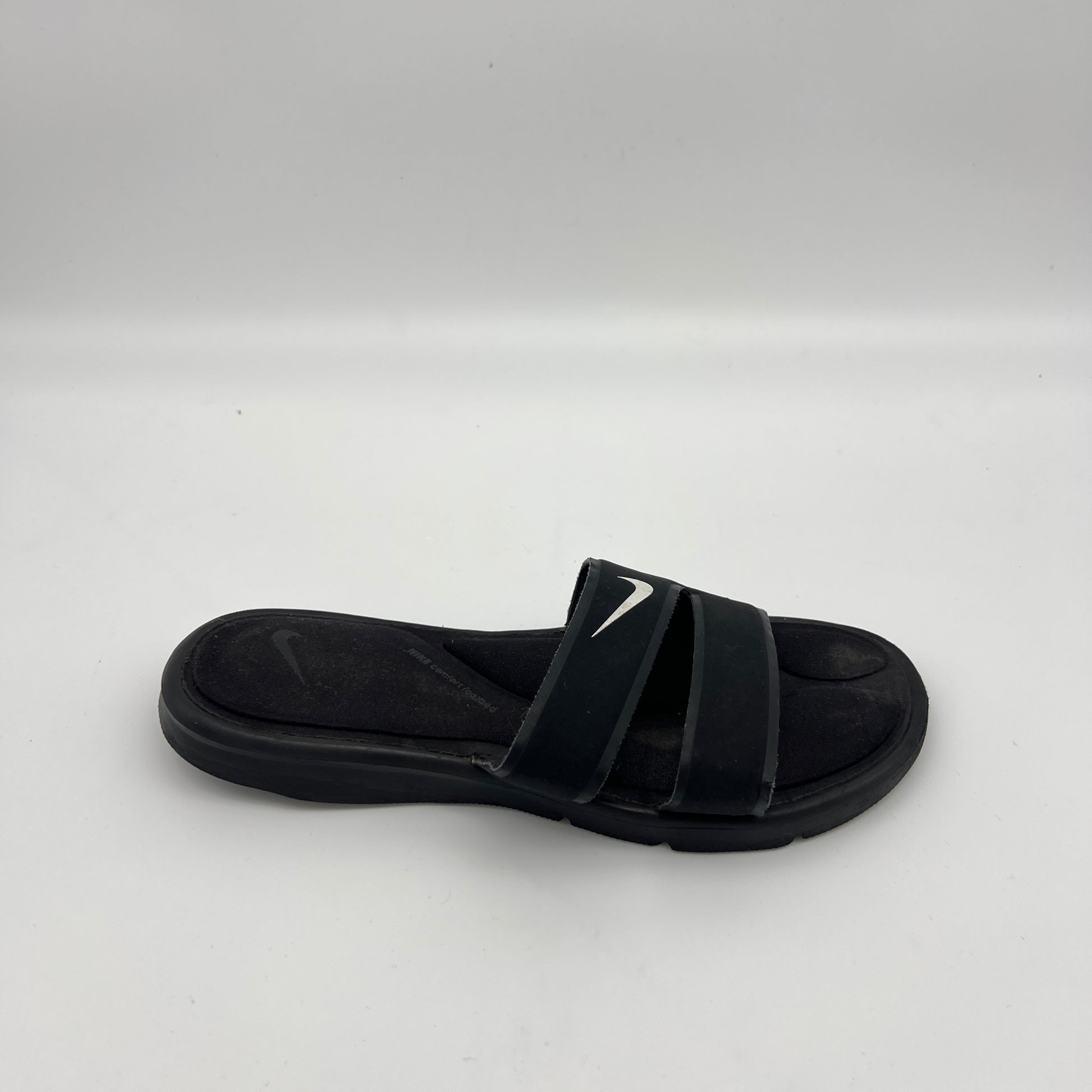 Black Nike Ultra Comfort 3 women's slide sandal with white swoosh and double strap design.