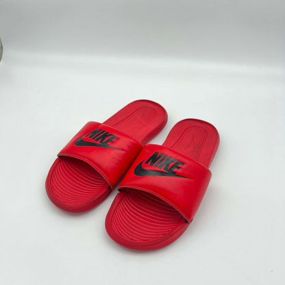 View of the outsole pattern on a red Nike Victori One slide designed for grip on multiple surfaces