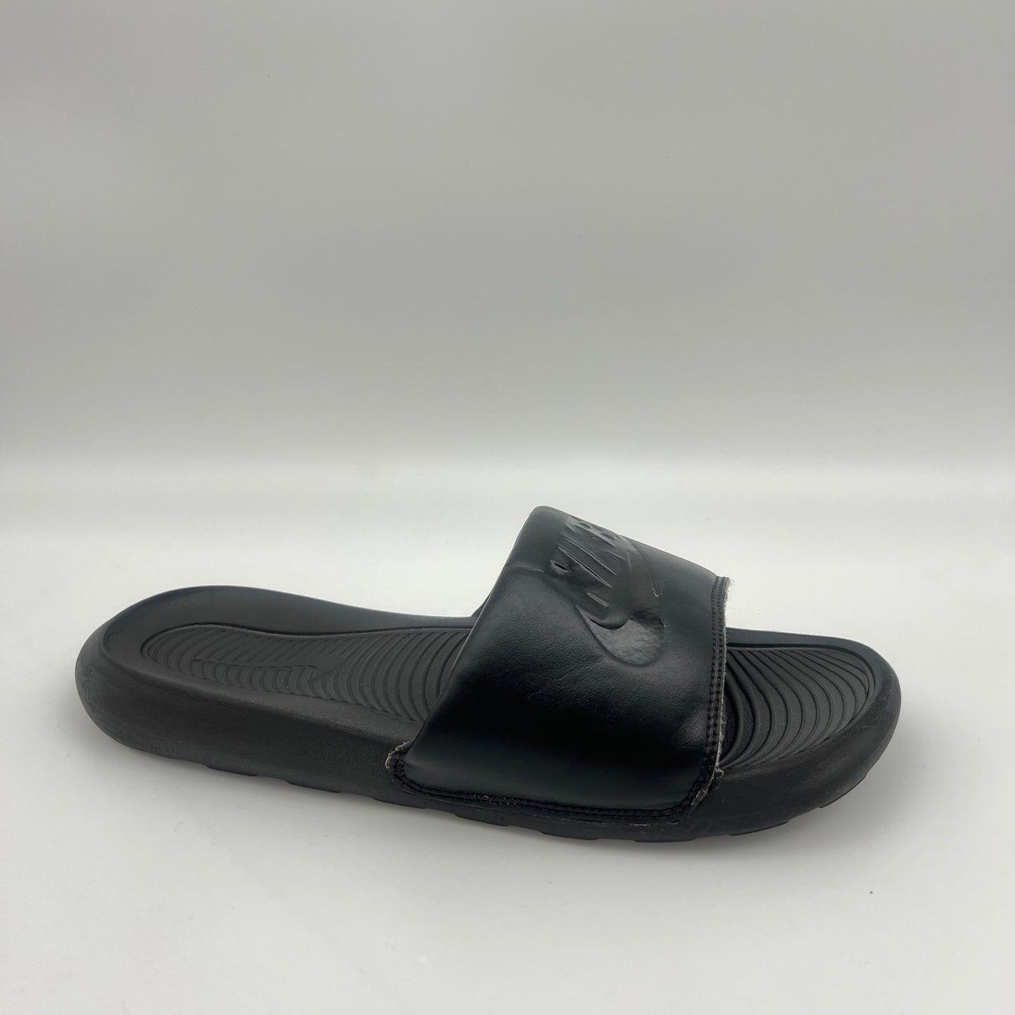 Black slide sandal on a light gray background