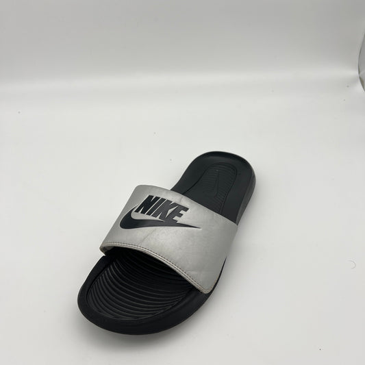 Gray and black slide sandal with Nike logo on a white background