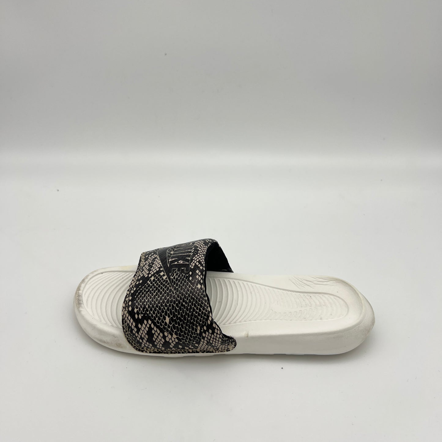 Nike Victori One women's slide sandal with black and white snakeskin print strap on a white footbed.