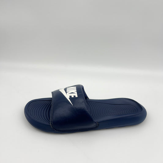 Navy blue slide sandal with Nike logo on a white background