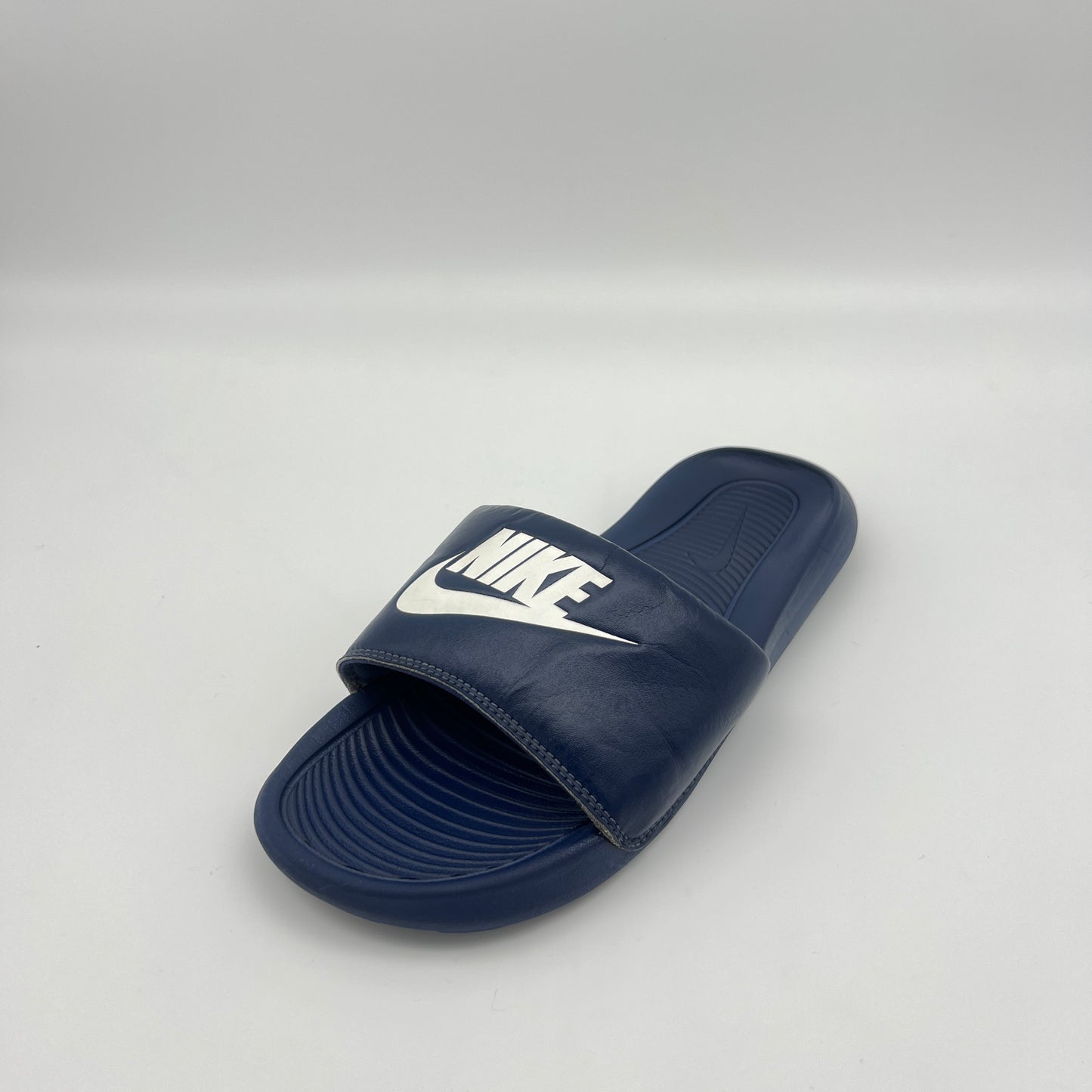 Navy blue Nike shower slides