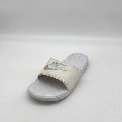 White slide sandal with Nike logo on a light gray background