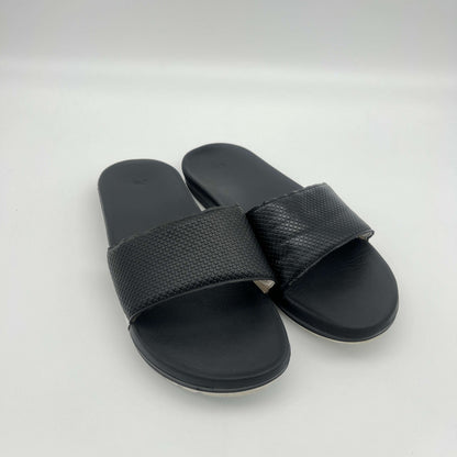 Black slide sandals on a white background