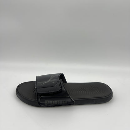 Puma Cool Cat 2.0 all-black men's slide sandal with adjustable logo strap and textured cushioned footbed.