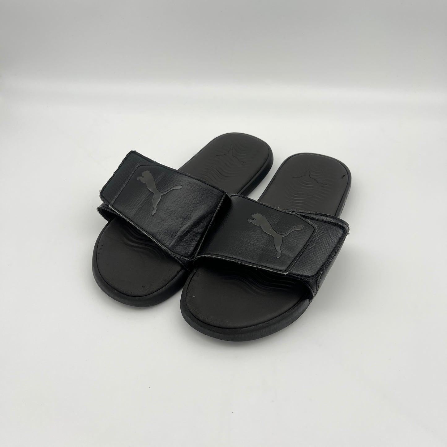 Black Puma slides on a white background