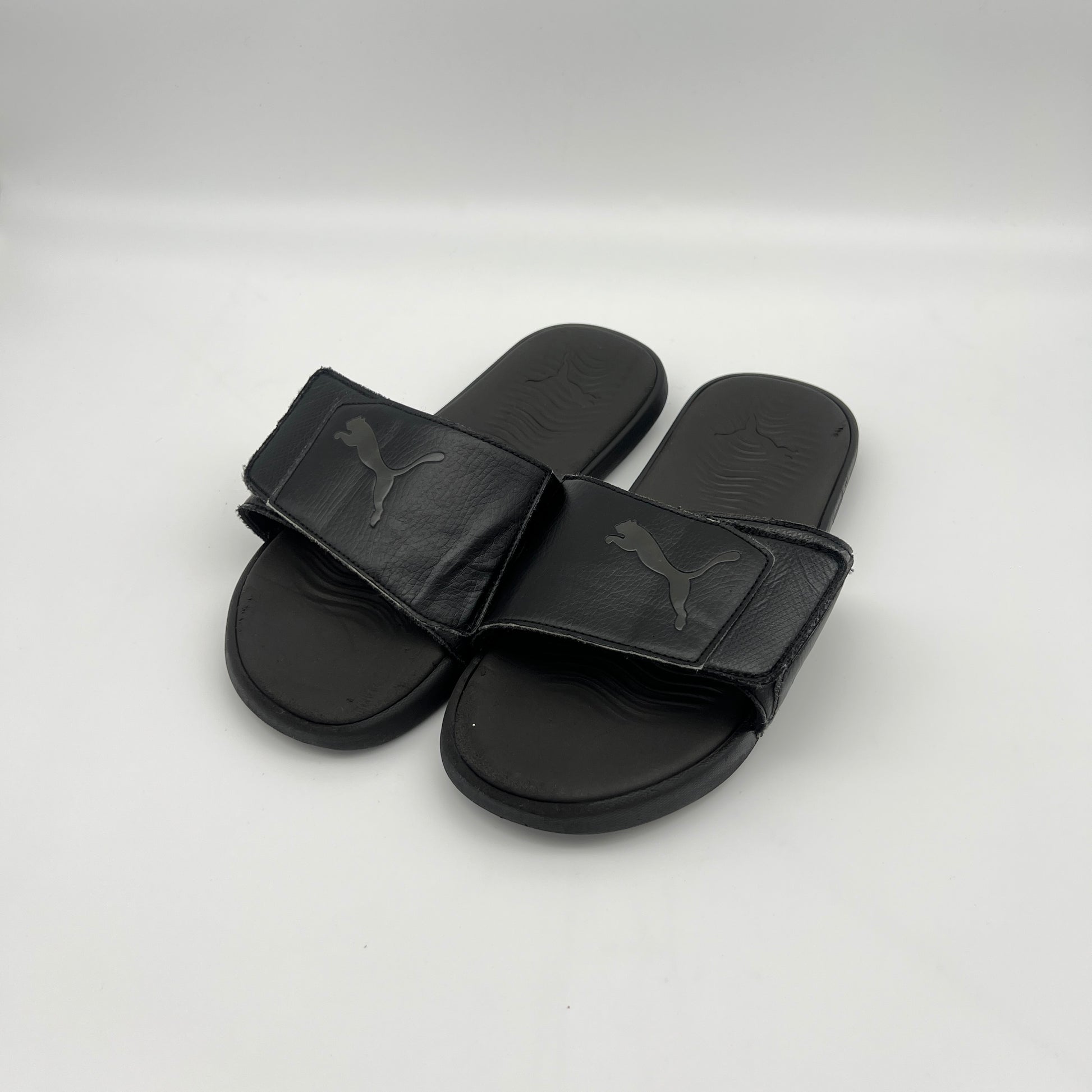 Black Puma slides on a white background