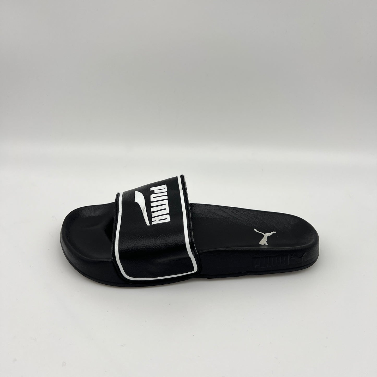  PUMA Leadcat 2.0 Elevate slide in black with a white PUMA logo and border on the strap and a contoured black footbed with heel logo