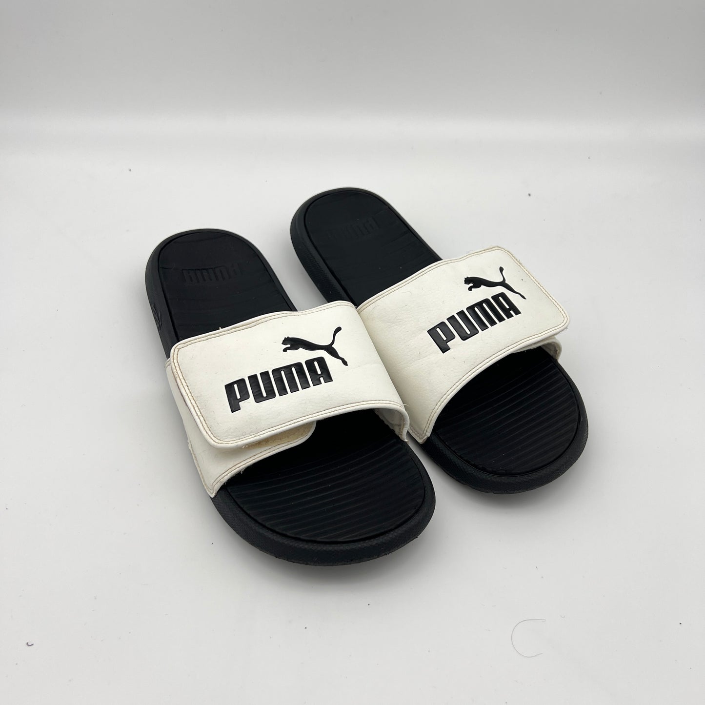 Lightweight PUMA Cool Cat sandals featuring a cushioned footbed and durable EVA outsole