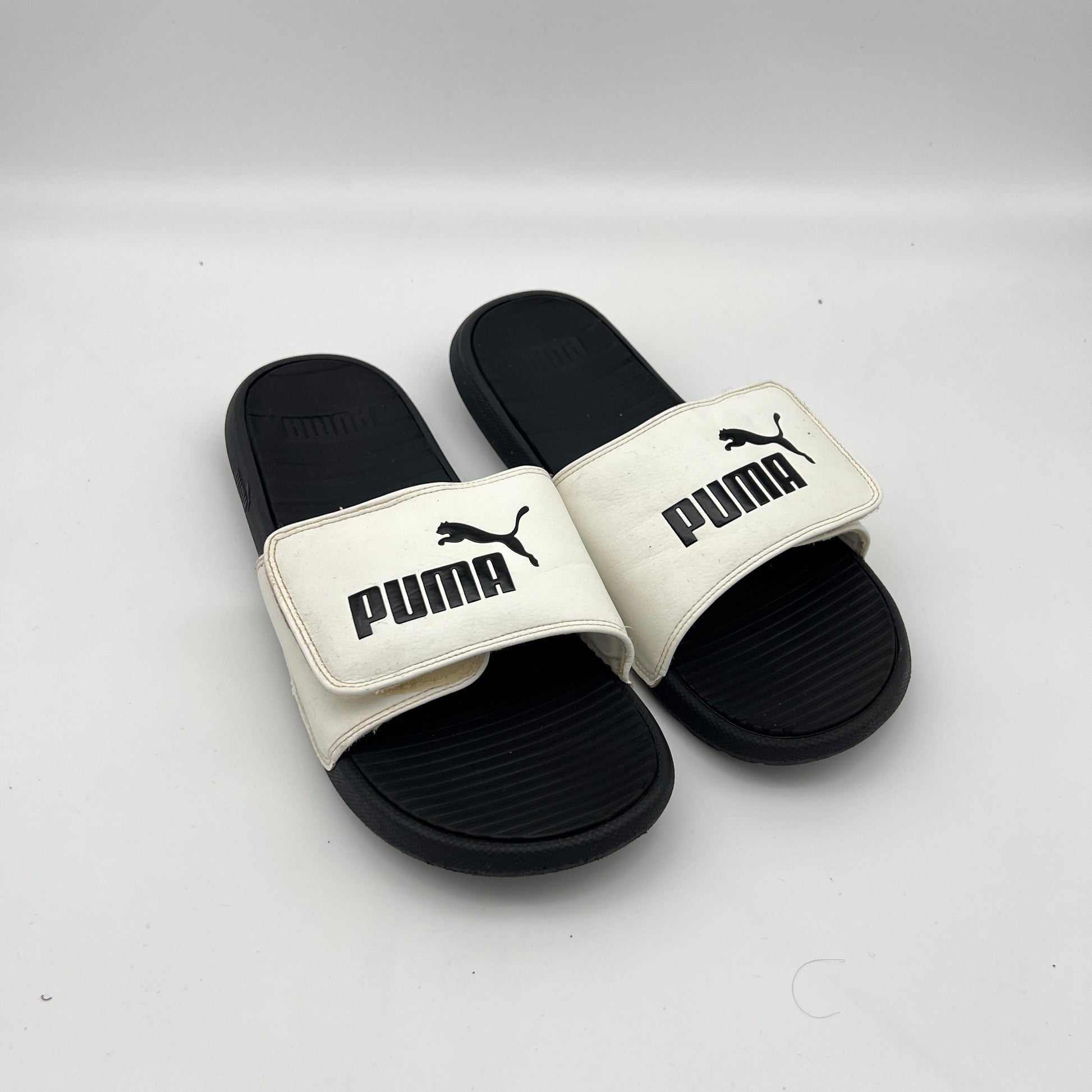 Lightweight PUMA Cool Cat sandals featuring a cushioned footbed and durable EVA outsole