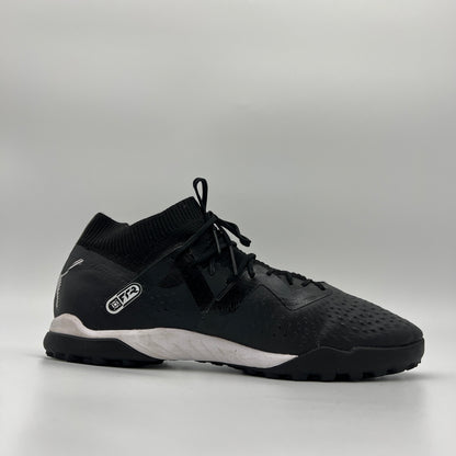 Side view of black mid-cut Puma Future Match TT soccer shoe with white logo.