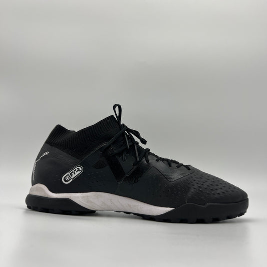 Side view of black mid-cut Puma Future Match TT soccer shoe with white logo.