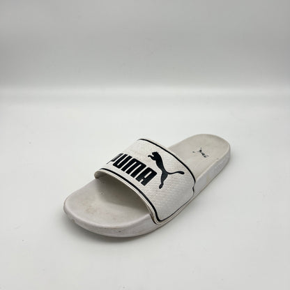 White slide sandal with Puma logo on a light gray background