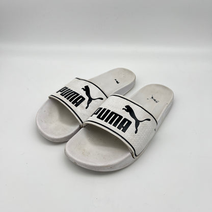 Pair of Puma slides on a white background