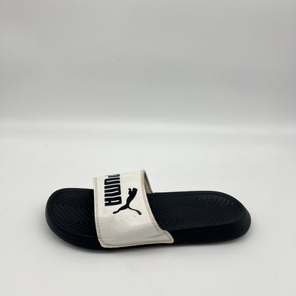 White Puma Popcat 20 slide sandal with black logo on a black textured footbed.