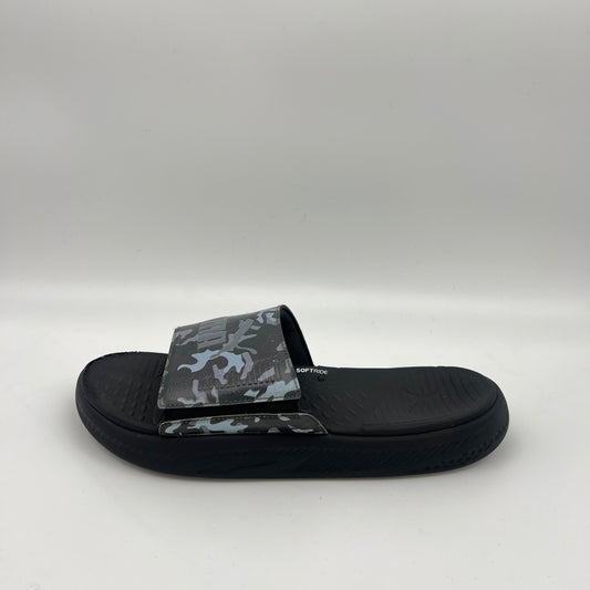 A side view of a black Puma Softride slide sandal featuring a grey and black camouflage patterned strap with an adjustable closure and a thick cushioned sole.