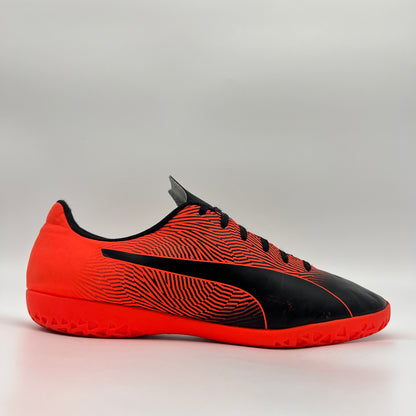 Side profile of a red and black Puma Spirit II IT indoor soccer shoe with a black PUMA formstrip and a red non-marking rubber sole.