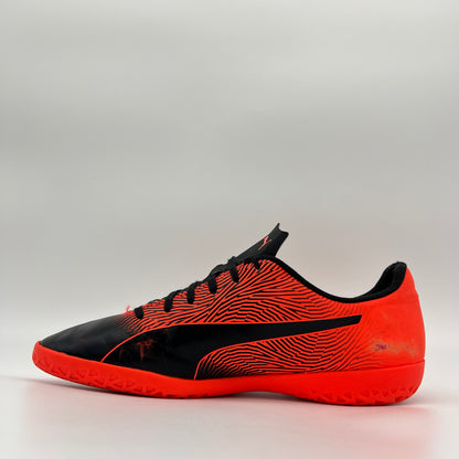 Black and orange sports shoe on a gray background