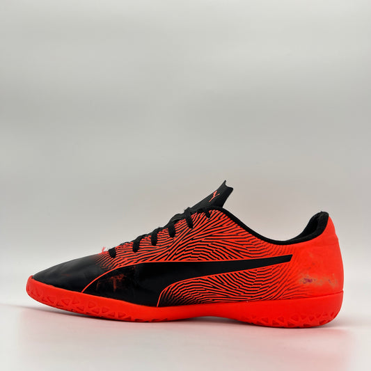 Black and orange sports shoe on a gray background