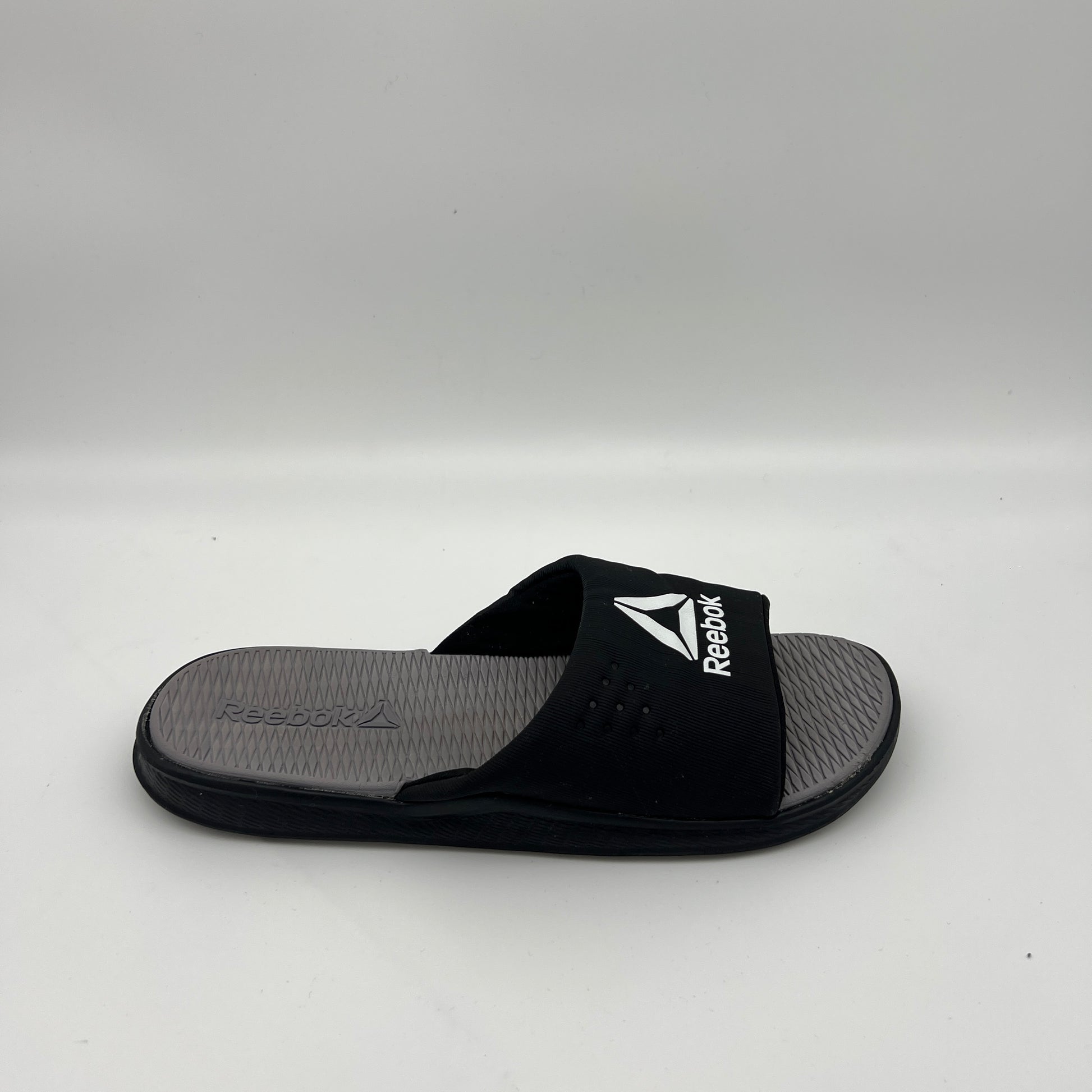Reebok men's Fulgere slides in black and grey with white logo.
