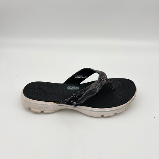 Side view of a black Skechers GOwalk 3 thong-style flip flop with a textured "Goga Mat" footbed, grey patterned fabric straps, and a thick white cushioned sole.