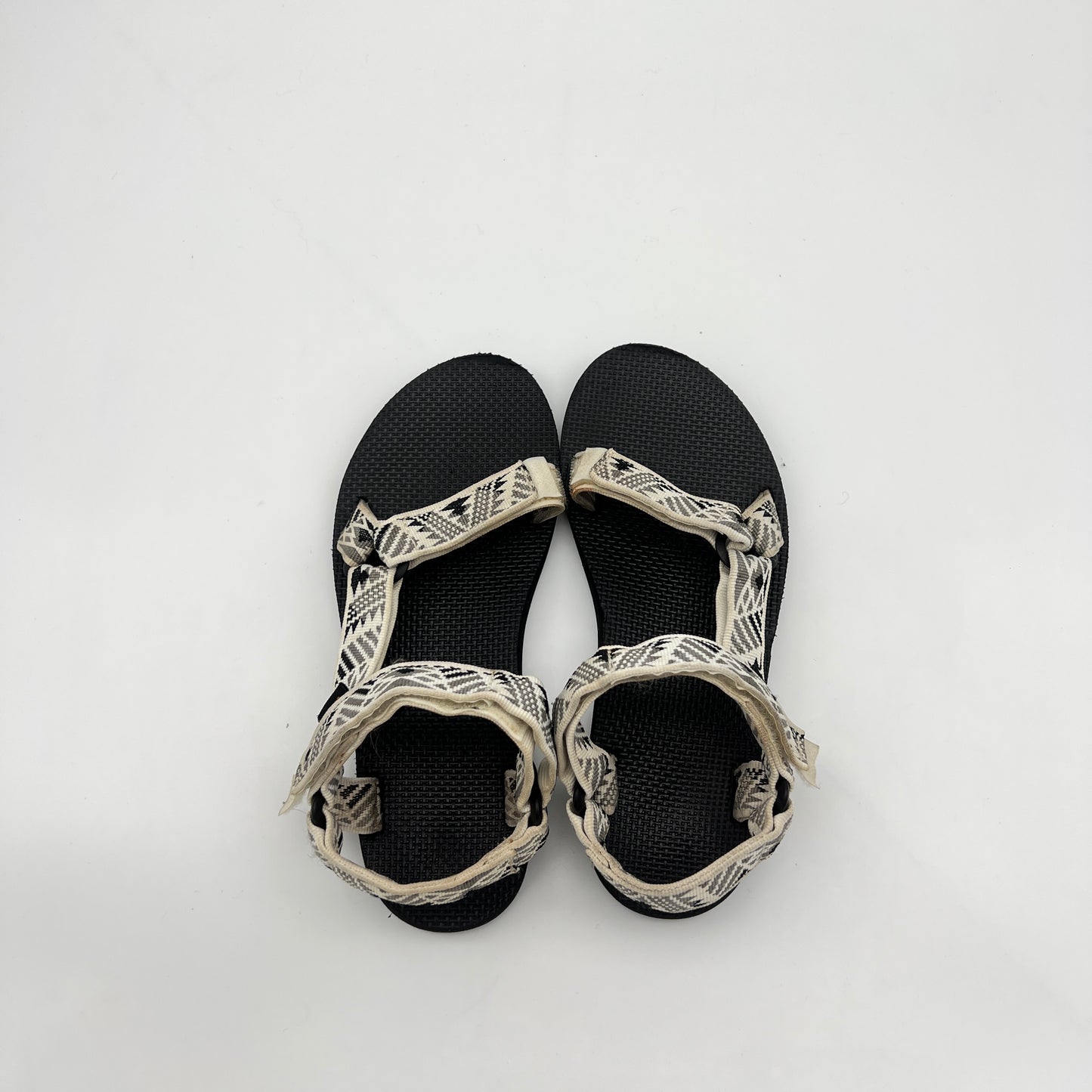 Black sandals with white straps on a white background