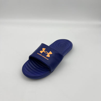 Blue slide sandal with Under Armour logo on a gray background