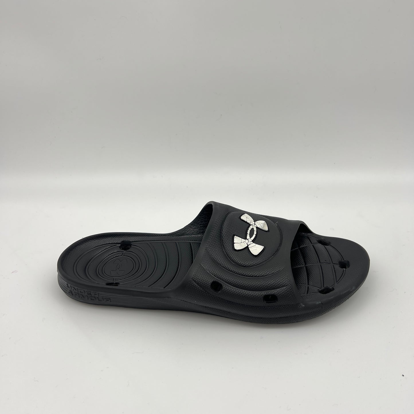 Under Armour Locker IV slides in black with white logo.