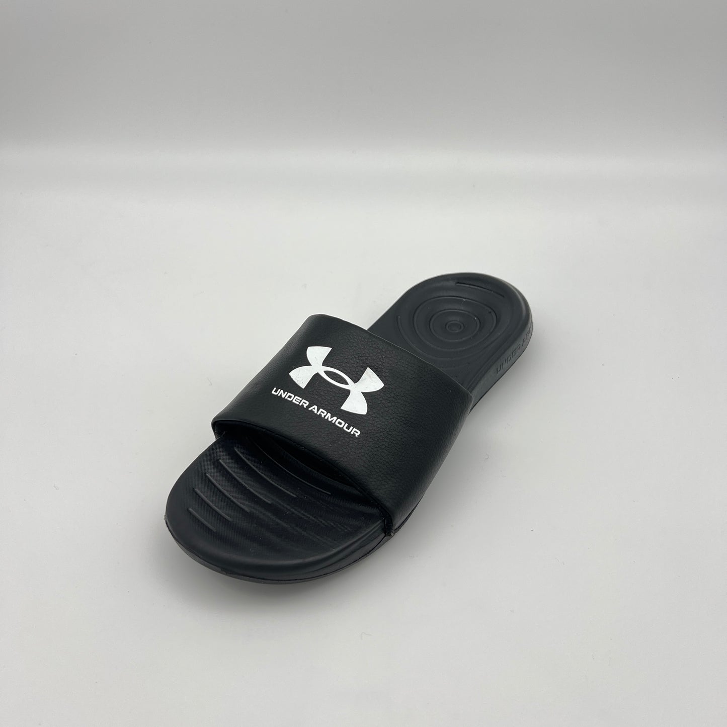 Under Armour athletic slides featuring an adjustable logo strap and memory foam cushioned sole