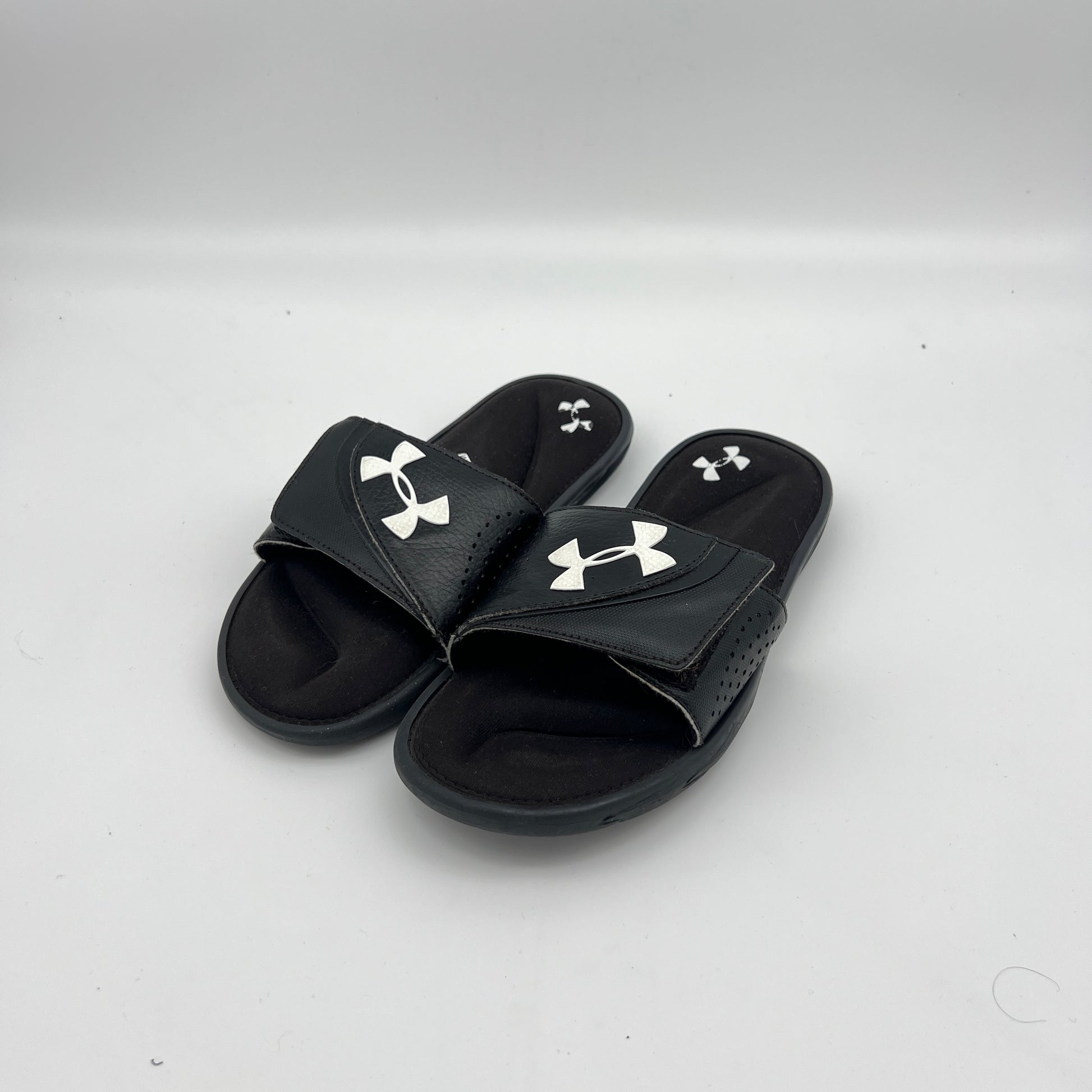 Lightweight black Under Armour sandals with a textured footbed and high-traction EVA outsole