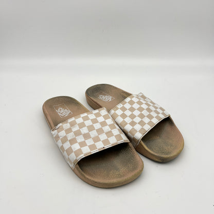 Pair of checkered slide sandals on a white background