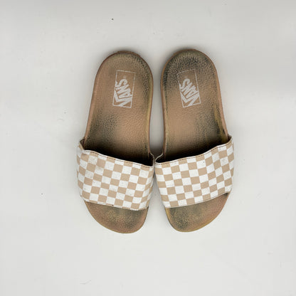 Pair of Vans slides with checkered soles on a white background