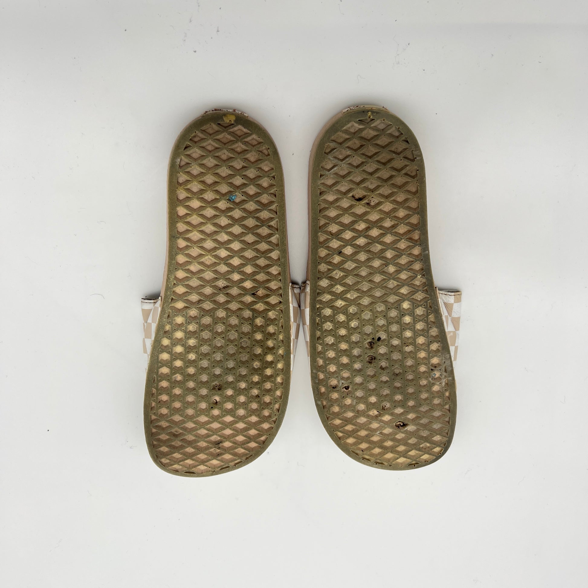 Pair of brown insoles with textured surface on a white background