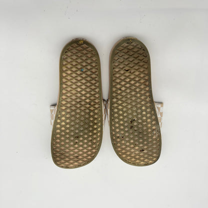Pair of brown insoles with textured surface on a white background