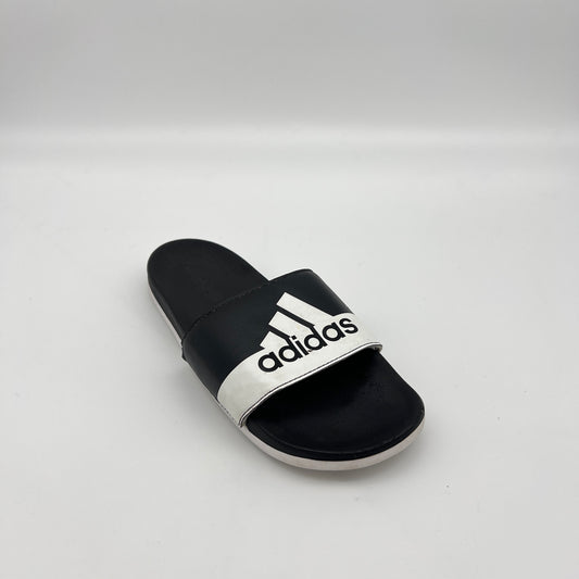 Black and white Adidas slide sandal on a light gray background