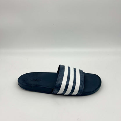 Side view of adidas Adilette Comfort slide in navy blue with marbled white 3-stripe strap