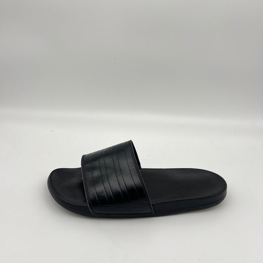 Side view of adidas Adilette Comfort slides in all-black with a textured bandage strap.