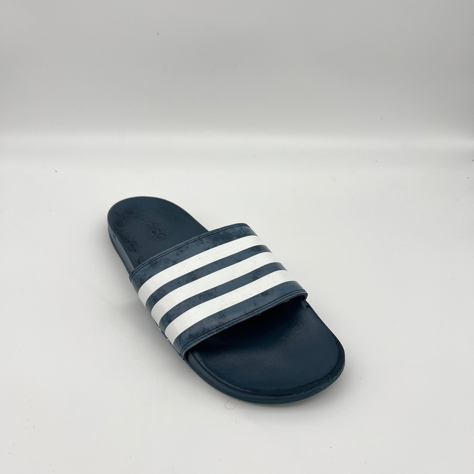 Men's adidas athletic slides featuring a navy blue cushioned footbed and textured bandage strap