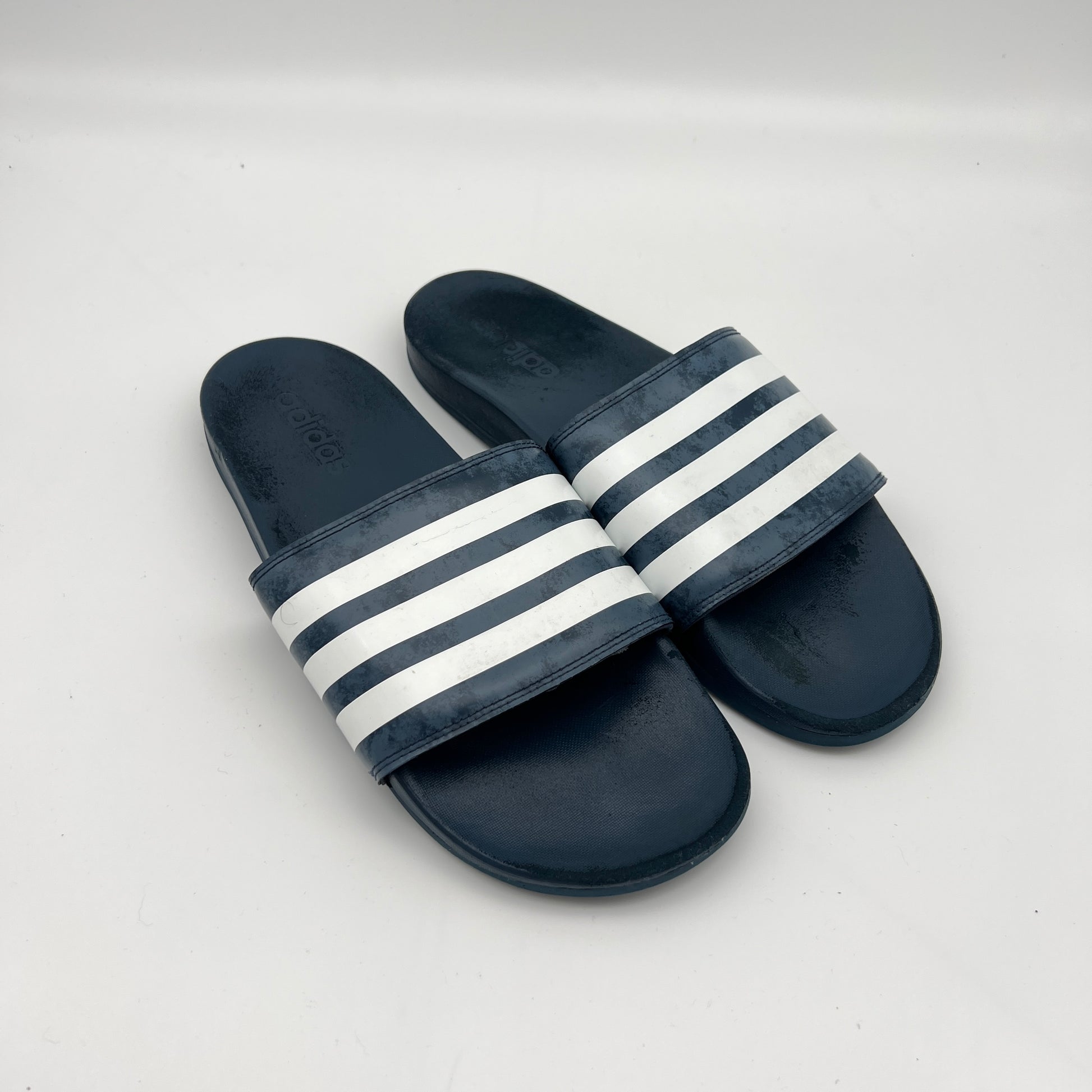 Lightweight navy adidas sandals with a contoured Cloudfoam sole and signature branding