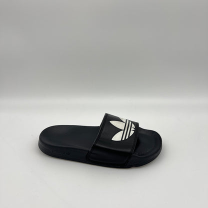 adidas Adilette Lite slide in black featuring a large white Trefoil logo on the strap and a contoured, cushioned black footbed.