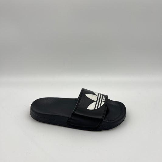 adidas Adilette Lite slide in black featuring a large white Trefoil logo on the strap and a contoured, cushioned black footbed.
