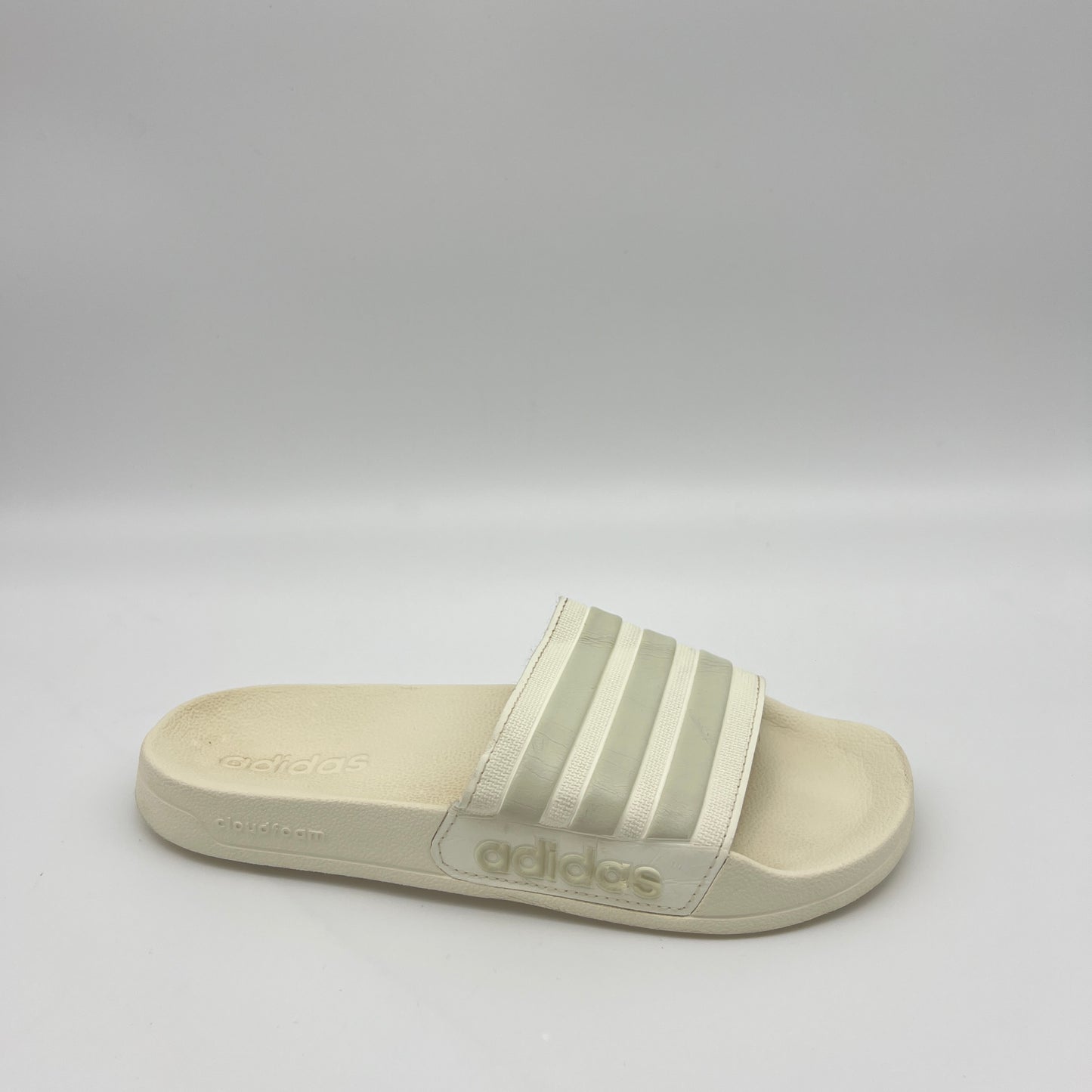 adidas-adilette-shower-slides-ig8776-side-view
off-white-adidas-slides-3-stripes-bandage-upper
adidas-cloudfoam-midsole-detail-shower-sandals
contoured-footbed-adidas-adilette-off-white
adidas-shower-slides-water-resistant-sole