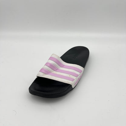 Single slide sandal with purple stripes on a white background
