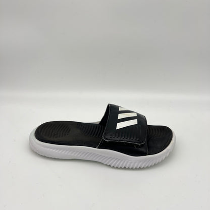 A side-angle view of a black adidas Alphabounce Slide 2.0 sandal featuring a white 3-Bar logo on an adjustable Velcro strap and a thick white Bounce sole.
