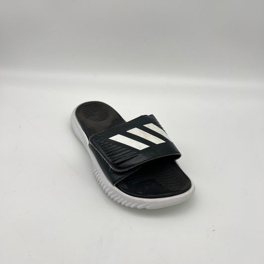 Black slide sandal with white stripes on a light gray background